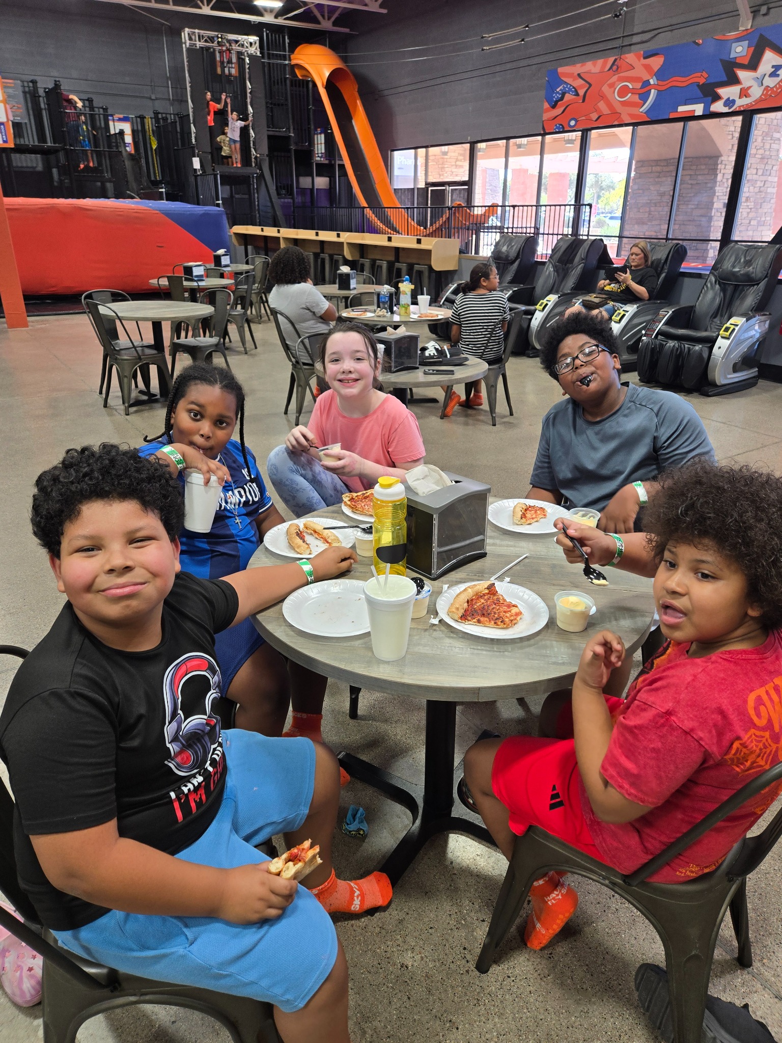 Heart Filled Academy students enjoying a meal together during their Sky Zone field trip